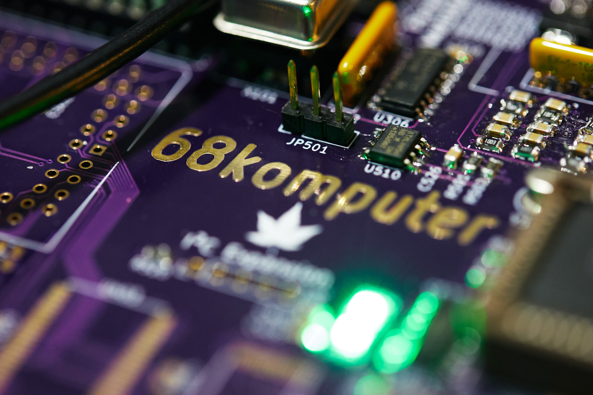 Photo of the 68komputer main board, showing the logo with lit status indicator lights.